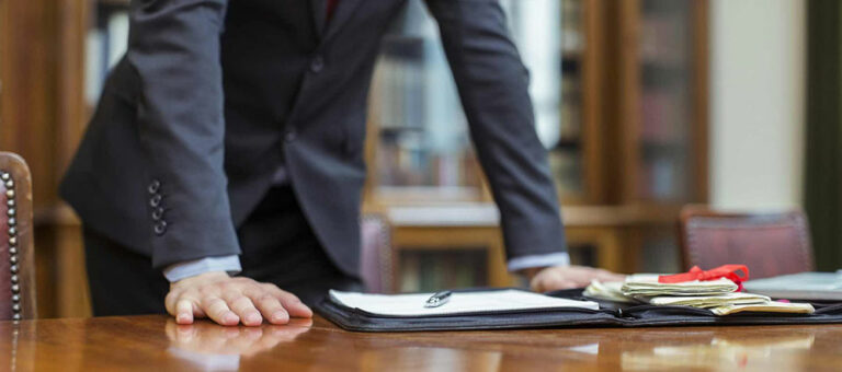 lawyer-hands-on-desk